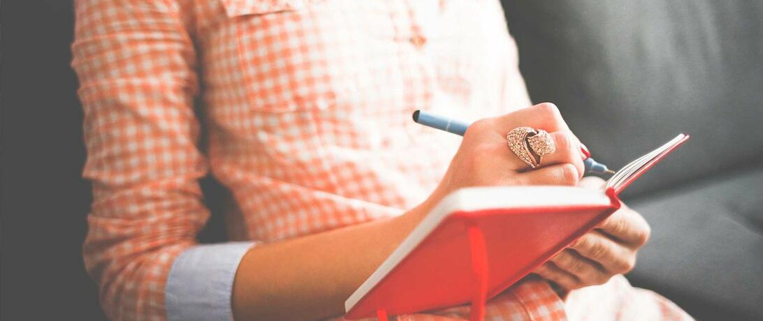 Woman writing in a journal