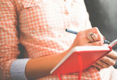 Woman writing in a journal